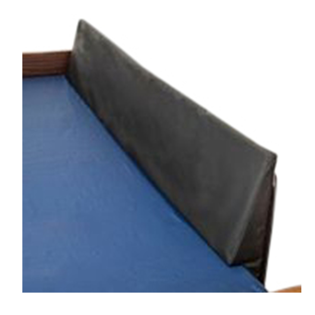 The Proactive Protekt® Rail Guard Wedge is a black padded bed bumper that fills mattress gaps on a wooden bed with a blue mattress, providing safety and entrapment prevention.